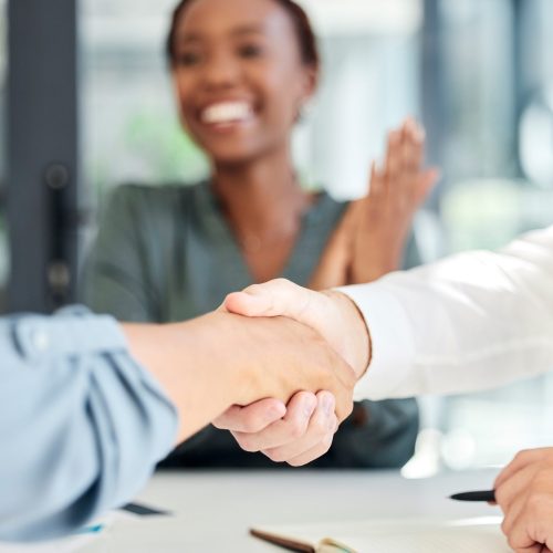 Handshake, deal and business partnership agreement with applause at startup office. Shaking hands, thank you and corporate welcome to new recruit or happy partner. Hand shake at recruitment meeting